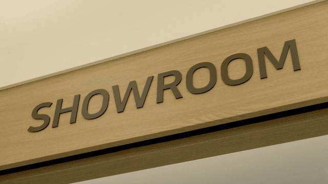 Showroom sign on a wooden panel