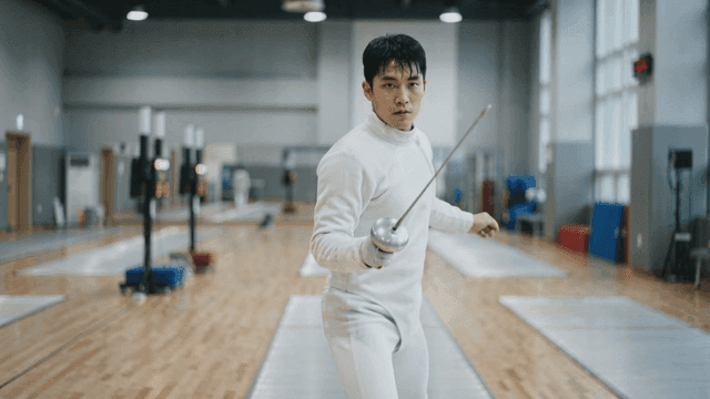 Fencer practicing in indoor gymnasium