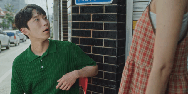 Sitting man talking to standing woman