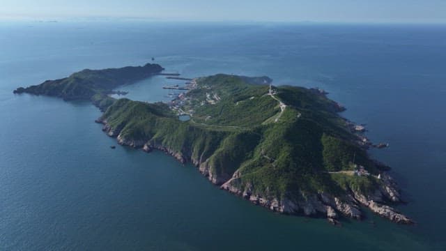 Coastal village nestled on a blue island in the middle of the sea