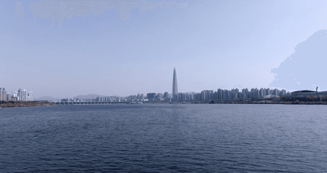 A city skyline with a river in the foreground