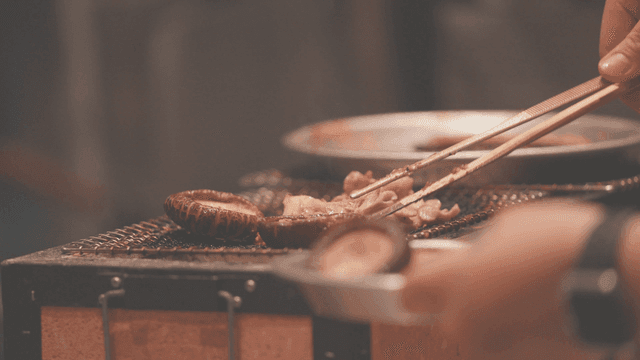 Various mushrooms grilling on barbecue