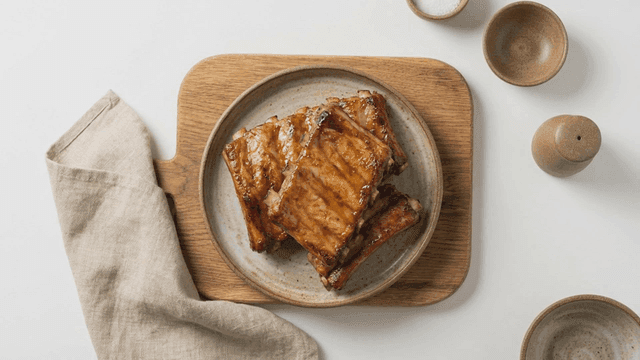 Grilled marinated pork ribs on wooden cutting board