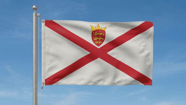 Jersey Island flag fluttering against clear sky