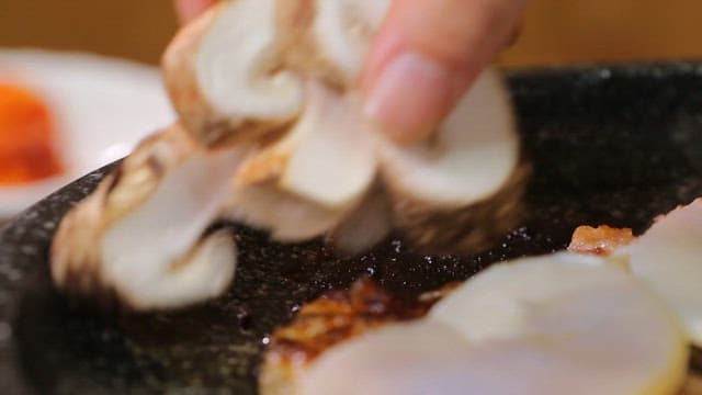 Beef, shiitake mushrooms and scallops cooked in a hot pan