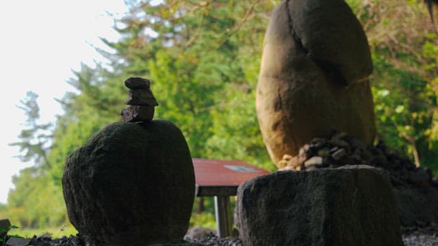 Rock tower surrounded by trees and greenery