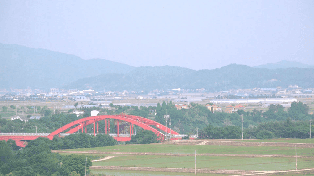 Red bridge over countryside