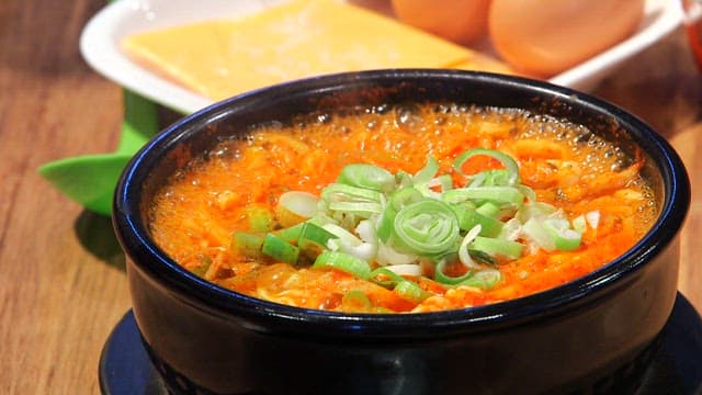 Spicy seafood ramyeon with eggs and cheese