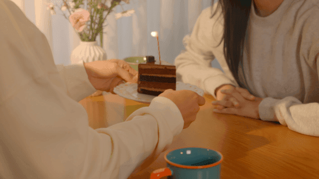 Candle-lit chocolate cake celebration for couple