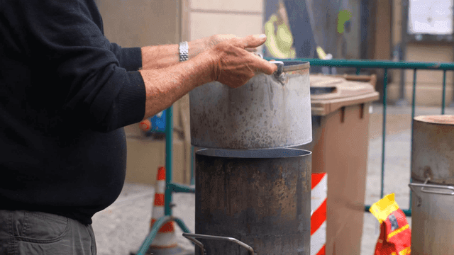 Street vendor cooking in metal pot
