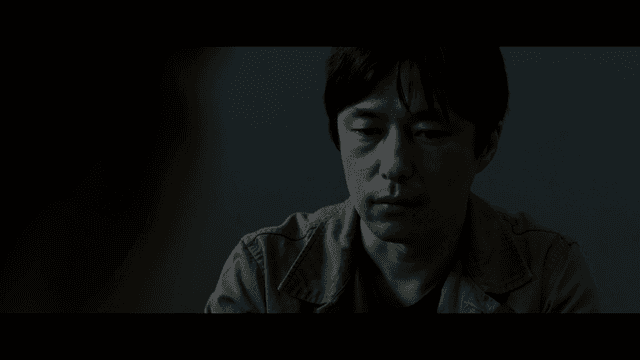 Man grieving in dark room