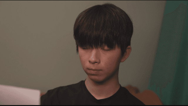 Man reading paper in his room