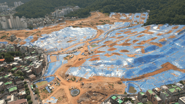 Construction site covered with blue tarpaulin