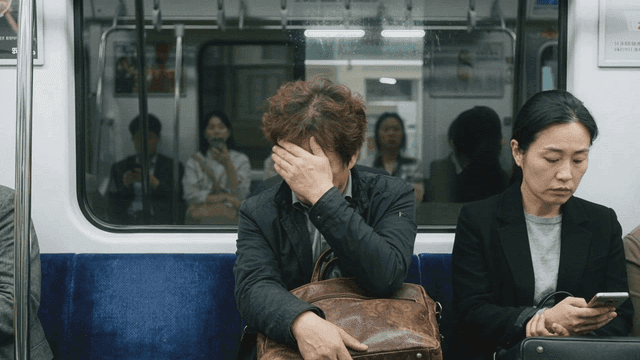 Tired man sitting on subway
