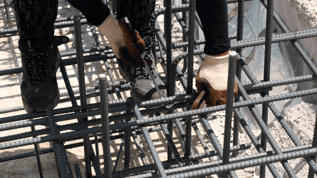 Worker tying rebar at a construction site