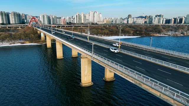 Clear Day Over City River and Traffic on Bridge