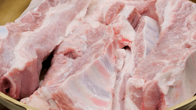 Raw pork ribs in a brassware