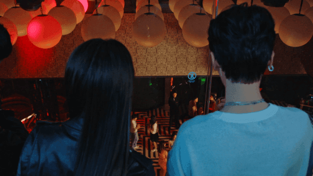 People observing a lively party scene