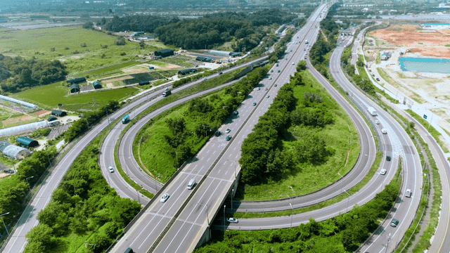 Aerial view of highway roundabout with surrounding greenery