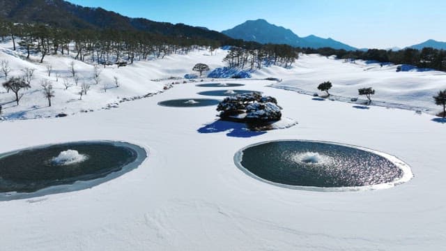 Snowy Landscape with Circular Ponds