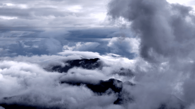 Clouds enveloping mountain peaks