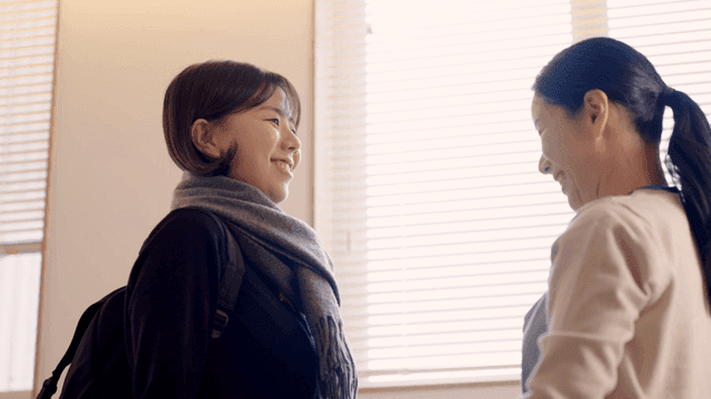 Mother fixing her daughter's scarf