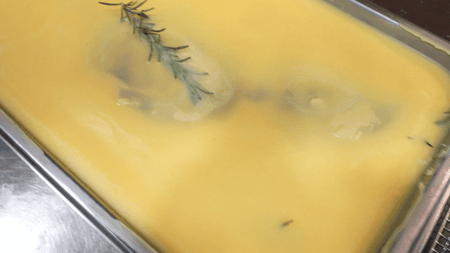 Tray of yellow butter with rosemary