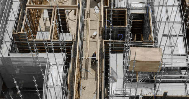 Construction site with workers and scaffolding
