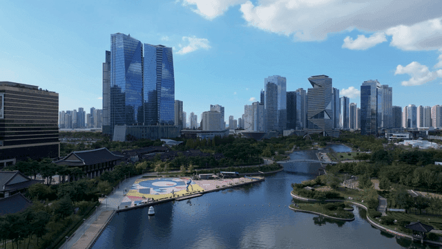 Modern cityscape with lakeside park and hanok houses