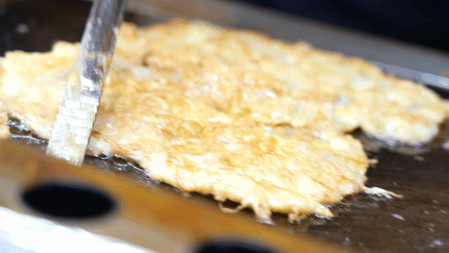 Golden brown pan-fried meat on hot iron plate