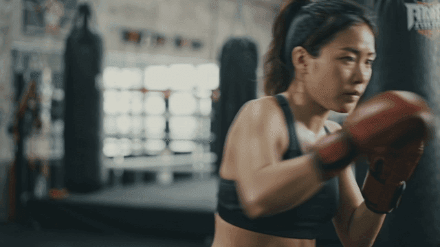 Woman practicing boxing at gym