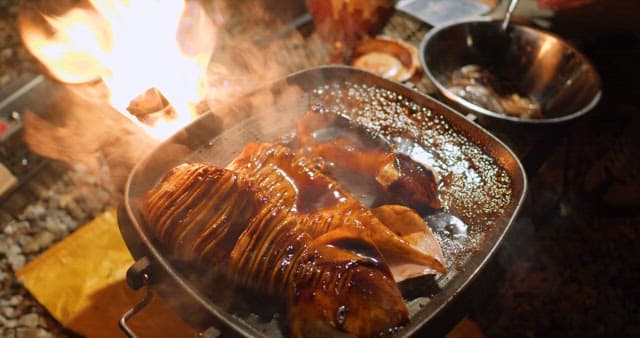 Sizzling squid being cooked on a grill