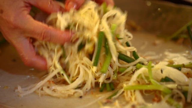 Close-up of hand mixing fresh vegetables