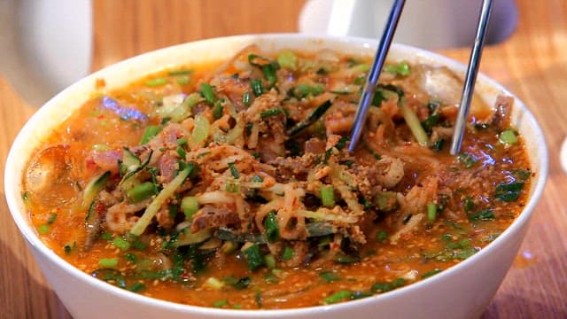 Fresh cold raw fish soup in a white bowl