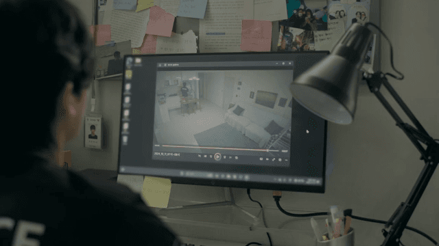 Person watching security footage on a monitor