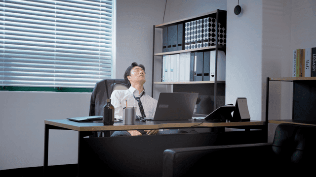 Man in office deep in thought