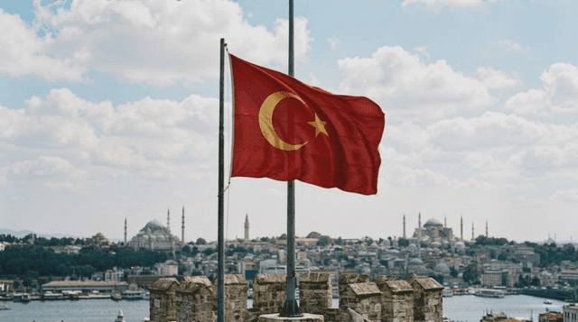 Turkish flag fluttering over historic cityscape