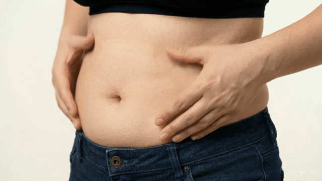 Person who massages their belly fat