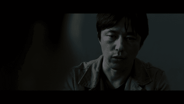 Man interrogating in dark room