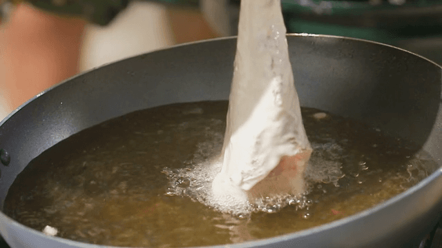 Fish being fried in hot oil