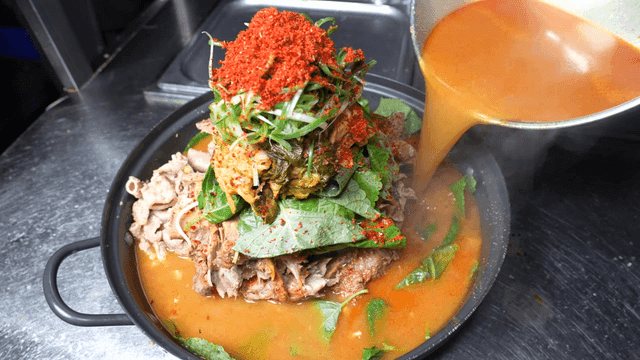 Hearty tripe and pork backbone stew with plenty of broth