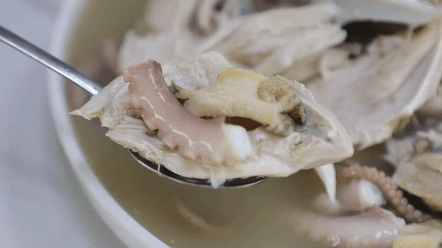 Spoonful of chicken and seafood from samgyetang
