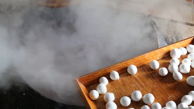 Making Red Bean Porridge with Rice Balls in a Steaming Cauldron