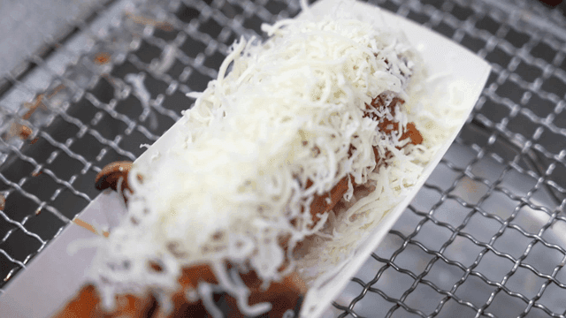 Grilled sausage topped with cheese