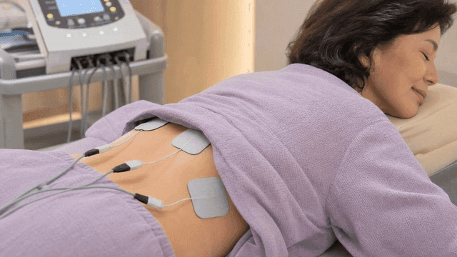 Middle-aged woman receiving electrotherapy