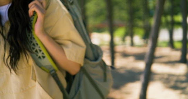 Person Leaning Against Tree with Backpack