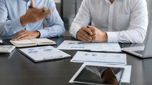 Business meeting with documents and laptops