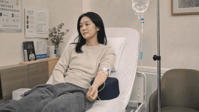 Female patient receiving IV drip at clinic