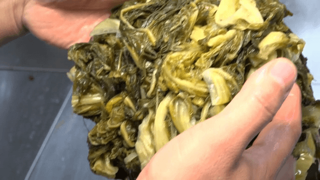 Hand lifting boiled cabbage