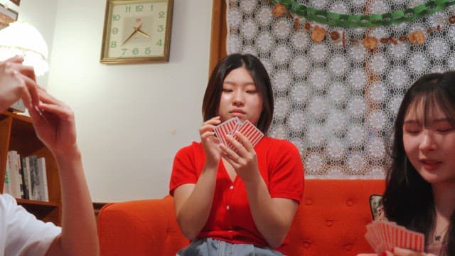 Friends playing cards in a cozy room